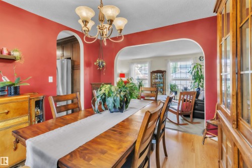 Arched doorways, wood-finish flooring, and a decorative ceiling light fixture - 76 Gariepy Crescent Nw, Edmonton, AB 