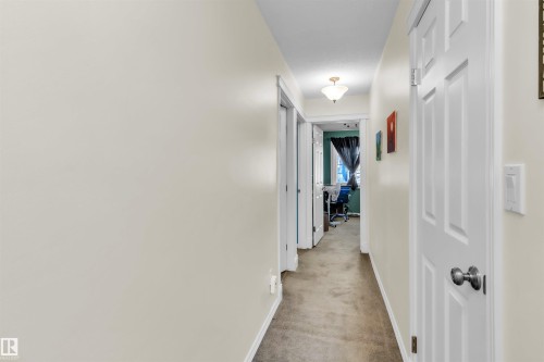 Hallway with neutral wall tones and carpeted flooring - 76 Gariepy Crescent Nw, Edmonton, AB 