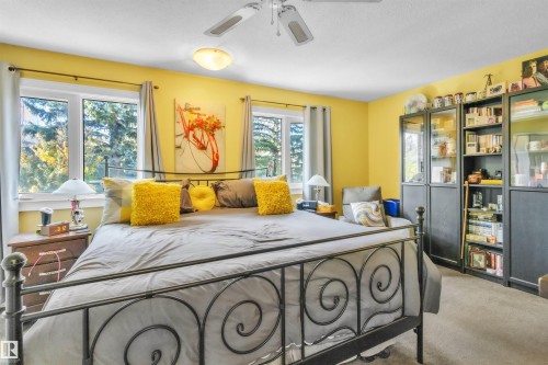 Recessed ceiling light, ceiling fan, multiple windows with sills, and carpeting - 76 Gariepy Crescent Nw, Edmonton, AB 