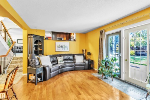 Wood-finish flooring throughout the main area - 76 Gariepy Crescent Nw, Edmonton, AB 