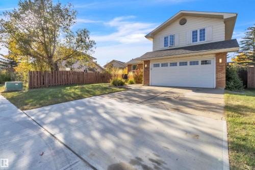 Two-story residence featuring brick and siding exterior, an attached two-car garage, and a concrete driveway - 76 Gariepy Crescent Nw, Edmonton, AB 