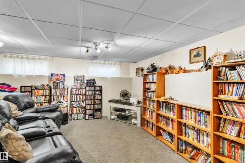 Carpeted flooring, drop ceiling with recessed lighting, and built-in shelving - 76 Gariepy Crescent Nw, Edmonton, AB 