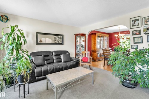 Archway leading to a dining area with wood-finish flooring - 76 Gariepy Crescent Nw, Edmonton, AB 