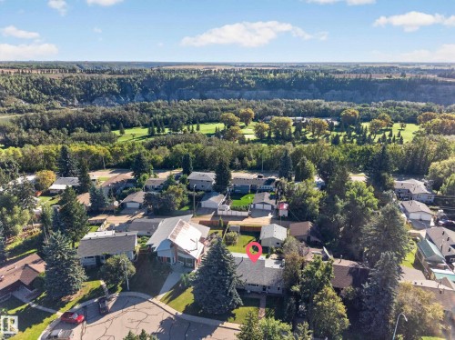 Residential property set within a treed neighborhood, featuring mature landscaping - 23 Clearwater, Devon, AB 