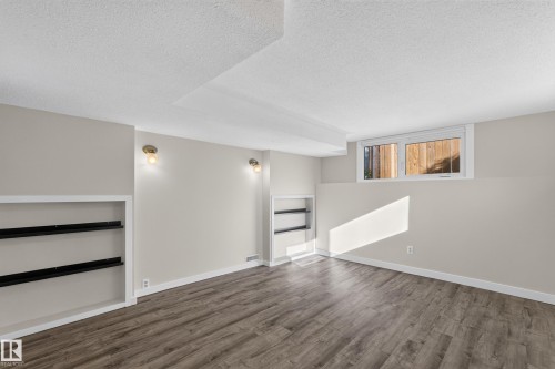 Recessed lighting, built-in shelving, wood-finish flooring, and wall-mounted light fixtures - 23 Clearwater, Devon, AB 
