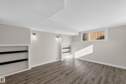 Recessed lighting, built-in shelving, wood-finish flooring, and wall-mounted light fixtures - 