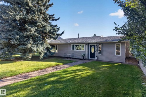 Single-story residence featuring light gray siding and a dark shingle roof - 23 Clearwater, Devon, AB 