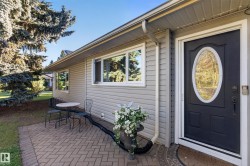 Entry with a dark paneled door featuring an oval decorative glass insert, a keypad lock, and a doorbell - 