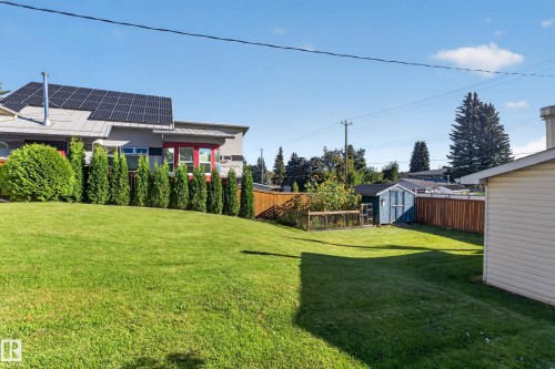 Expansive lawn with perimeter fencing and a separate storage shed - 23 Clearwater, Devon, AB 