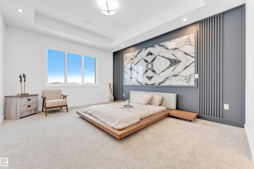 Recessed lighting, large window, tray ceiling, textured accent wall, and carpeted flooring - 2 Tenuto Link, Spruce Grove, AB 