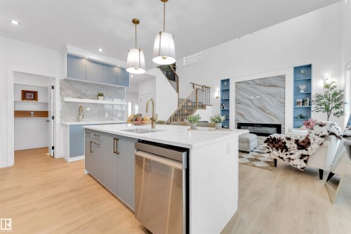 Kitchen island with an undermount sink and a stainless steel dishwasher - 2 Tenuto Link, Spruce Grove, AB 