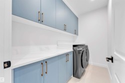 Light blue cabinetry with gold-tone hardware - 
