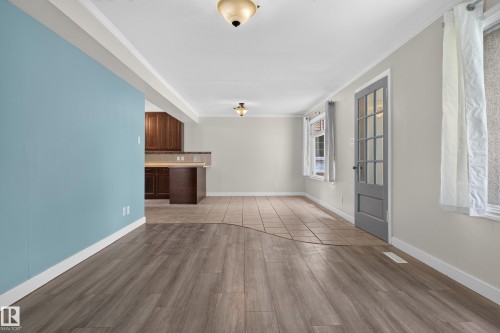 Wood-finish flooring, tiled flooring, built-in cabinetry, and a glass-paneled door - 11549 88 Street Nw, Edmonton, AB 