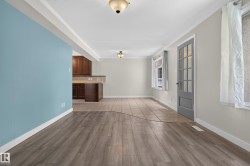 Wood-finish flooring, tiled flooring, built-in cabinetry, and a glass-paneled door - 