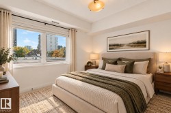 Expansive window, neutral wall color, upholstered headboard, ceiling-mounted light fixture, light-toned flooring - 