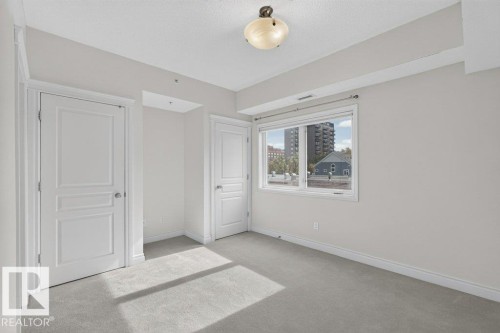 Recessed lighting, light-colored carpeting, white wall paint, and a window with white trim - #306 10232 115 St Nw, Edmonton, AB 