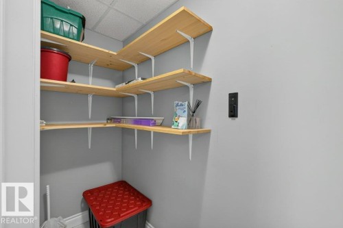 Corner shelving system with natural wood shelves and white brackets - #306 10232 115 St Nw, Edmonton, AB 