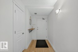 Light wood-finish flooring with white baseboards and walls - 