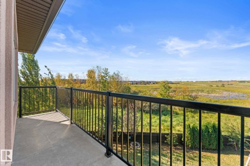 Outdoor balcony featuring concrete flooring and black metal railings - 229 Albany Drive Nw, Edmonton, AB 