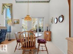 Vaulted ceiling with decorative trim, rear-facing window, and glass-paneled door - 