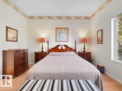 Wood-finish flooring with white walls and a large window - 