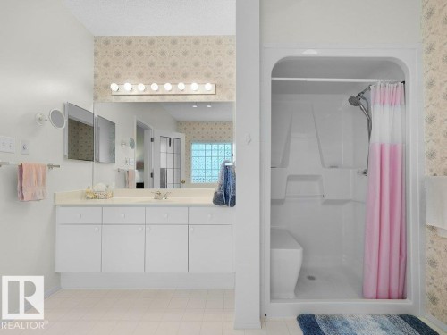 Full vanity with extensive counter space, integrated sink, and white cabinetry - 156 Phillips Row Nw, Edmonton, AB 