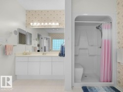 Full vanity with extensive counter space, integrated sink, and white cabinetry - 