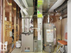 Lennox furnace, Rheem water heater, exposed wood framing, white PVC piping, galvanized ductwork - 