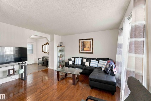 Hardwood flooring, arched doorway, and light-toned walls - 3524 Mclean Crescent Sw, Edmonton, AB 