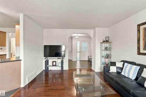 Hardwood-finish flooring, white walls, and a recessed entryway with a white door - 3524 Mclean Crescent Sw, Edmonton, AB 