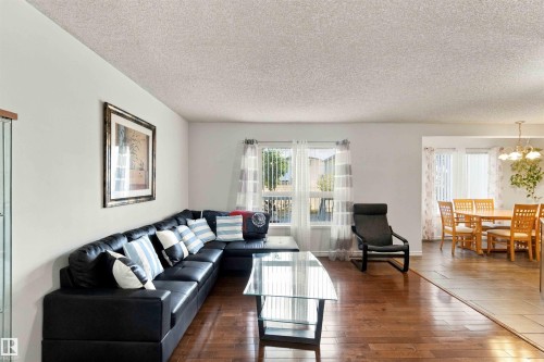 Hardwood flooring, light-toned walls, and a textured ceiling - 3524 Mclean Crescent Sw, Edmonton, AB 