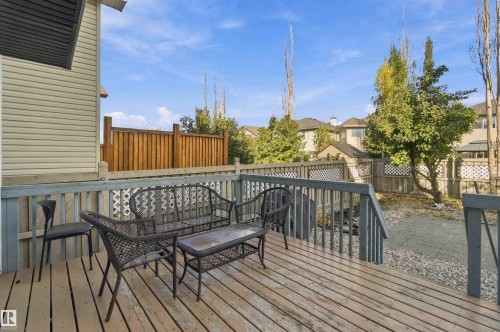 Expansive composite deck featuring horizontal wood-finish decking, black aluminum railings, and integrated seating areas - 3524 Mclean Crescent Sw, Edmonton, AB 
