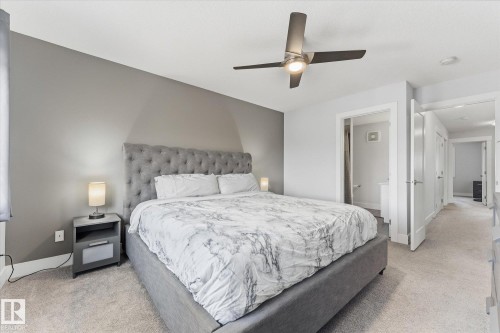 Neutral wall paint, ceiling fan with integrated lighting, light-toned carpet flooring, white trim and interior doors - #15 4835 Wright Dr Sw, Edmonton, AB 