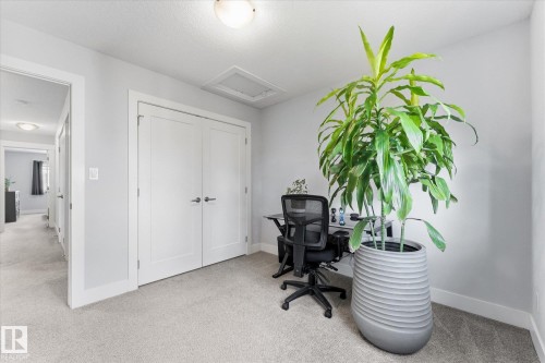 Recessed ceiling light, light gray wall paint, light-toned carpet, white trim, and white double doors with matte black hardware - #15 4835 Wright Dr Sw, Edmonton, AB 