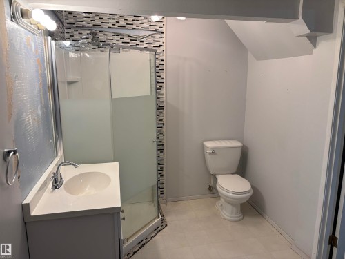 Vanity with integrated sink, chrome faucet, and white countertop - 7623 130 Avenue Nw, Edmonton, AB 
