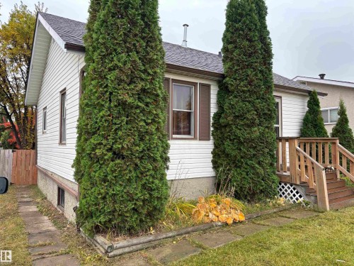 White siding exterior with a dark shingle roof - 7623 130 Avenue Nw, Edmonton, AB 