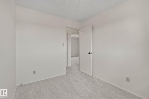 Light gray carpet flooring and white painted walls - 14411 23 Street Nw, Edmonton, AB 