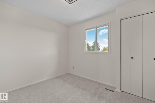 White walls with light-toned carpeting - 14411 23 Street Nw, Edmonton, AB 
