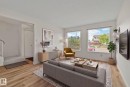 Bright living area with large windows, wood-finish flooring, and a neutral color palette - 14411 23 Street Nw, Edmonton, AB 