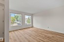 Wood-finish flooring, white painted walls, and two large windows - 14411 23 Street Nw, Edmonton, AB 