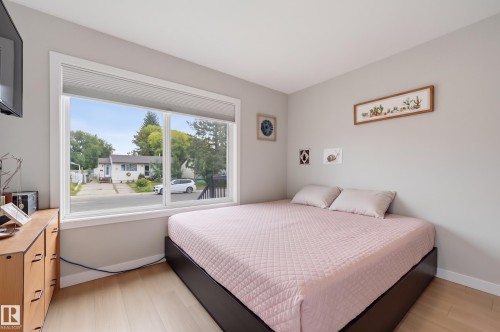 Light wood-finish flooring with neutral wall tones - 9020 152 Street Nw, Edmonton, AB 