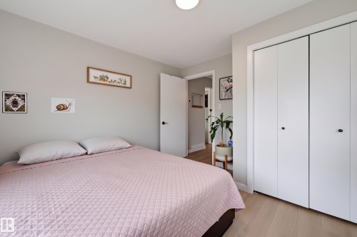 Light wood-finish flooring, recessed ceiling lighting, and a white bi-fold closet - 9020 152 Street Nw, Edmonton, AB 