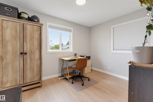 Light-toned wood-finish flooring, white trim, and neutral wall paint - 9020 152 Street Nw, Edmonton, AB 
