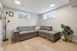 Recessed ceiling lighting, wood-finish flooring, and white trim throughout - 