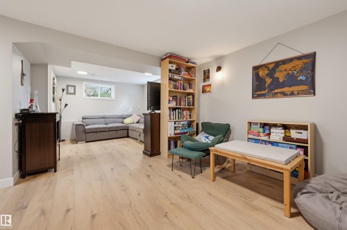 Light wood-finish flooring throughout, light gray wall paint, and recessed ceiling lighting - 9020 152 Street Nw, Edmonton, AB 
