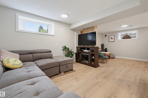 Recessed lighting and two windows illuminate this expansive room, featuring light wood-finish flooring - 9020 152 Street Nw, Edmonton, AB 