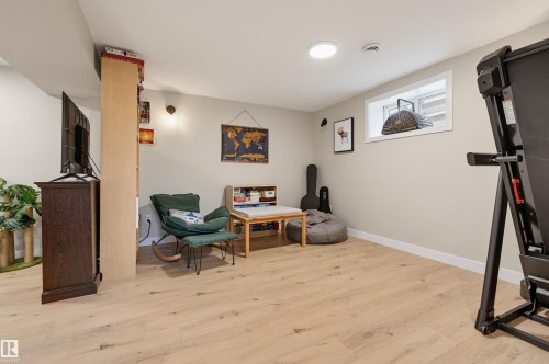 Recessed lighting, wood-finish flooring, light-toned walls, built-in shelving, and a window with white trim - 9020 152 Street Nw, Edmonton, AB 