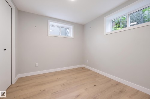 Light-colored wood-finish flooring, recessed ceiling lighting, and white trim - 9020 152 Street Nw, Edmonton, AB 