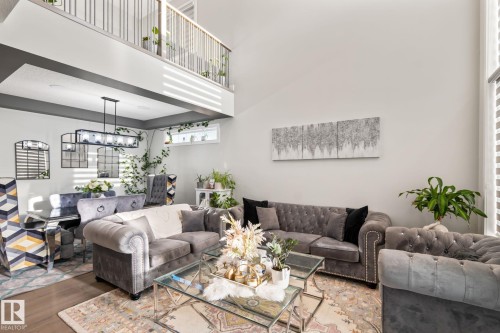 Two-story living area with high ceilings and wood-finish flooring - 824 34 Ave Nw, Edmonton, AB 