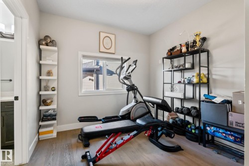 Light wood-finish flooring, a single window, and a white corner shelving unit - 824 34 Ave Nw, Edmonton, AB 